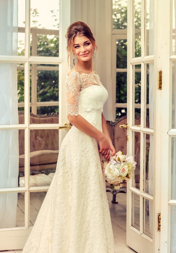 Bride in a lace dress holding a bouquet