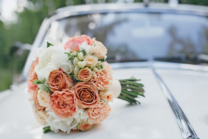 Wedding bouquet of roses on a car