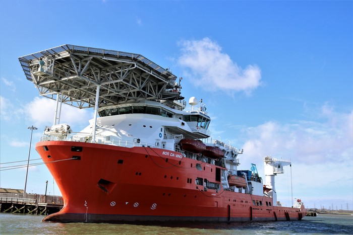 The offshore vessel NOR DA VINCI docked under a blue sky