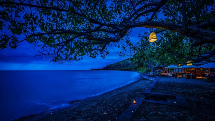 Beachfront restaurant at night in Bali, Indonesia