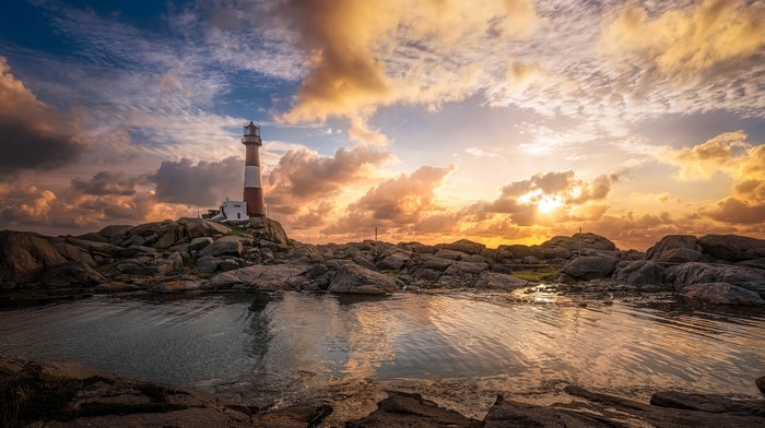 Lighthouse on rocky coast at sunset, Nymark Rogaland, Norway