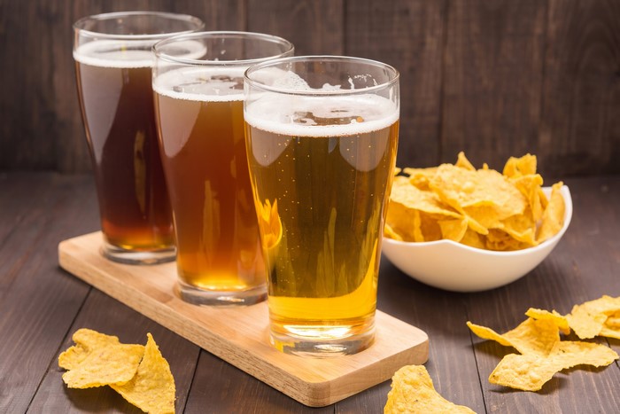 Three glasses of beer with chips