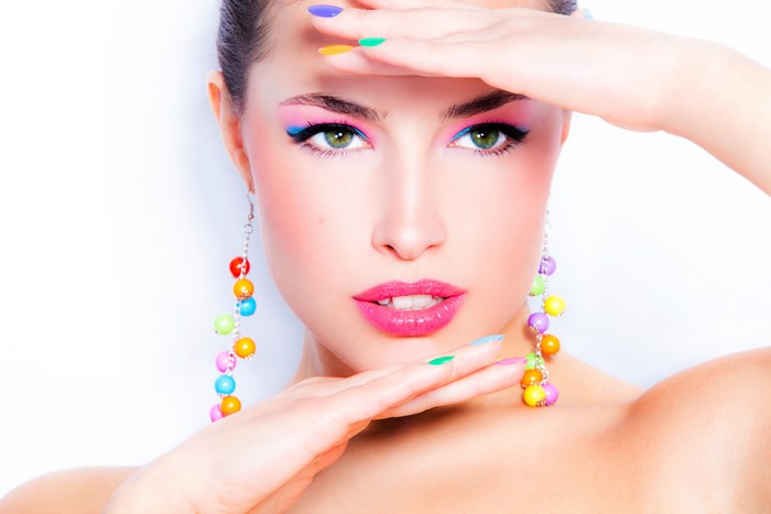 Model with colorful makeup and earrings