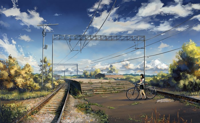 Girl with bicycle near railroad tracks