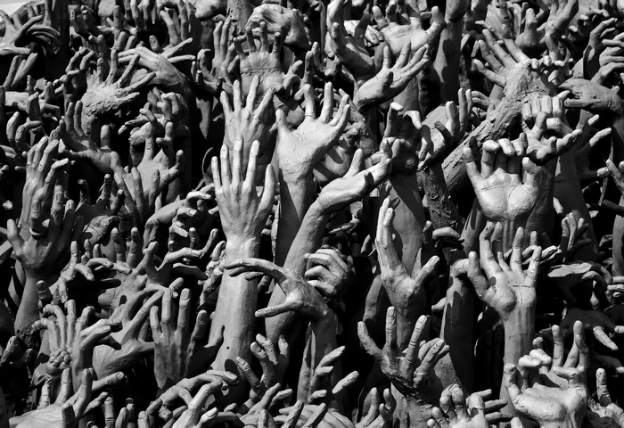 A multitude of hands reaching upwards