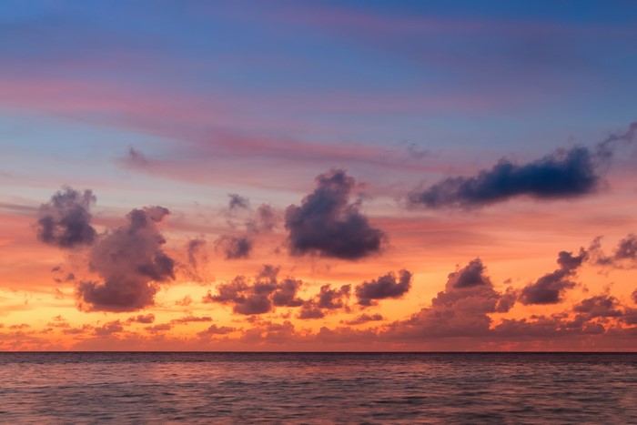 Sunset over the ocean with colorful clouds