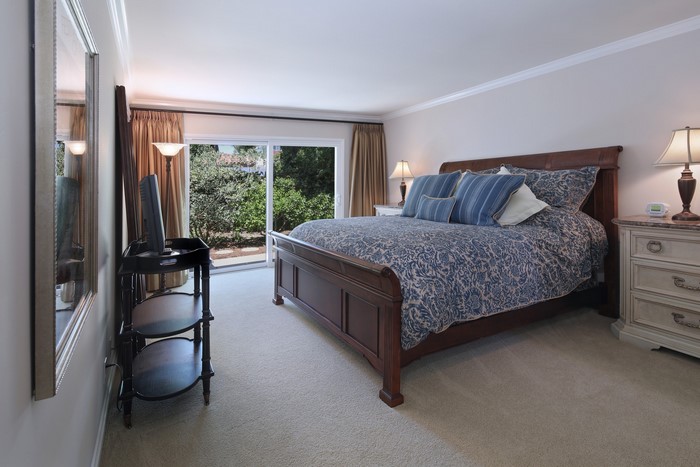 Bedroom with a large bed and sliding glass doors