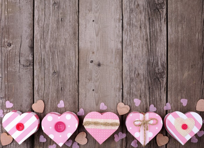 Valentine's Day heart-shaped gift boxes on wood planks