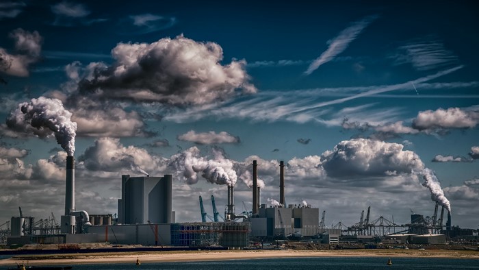 Industrial factory with smoke stacks under a cloudy sky