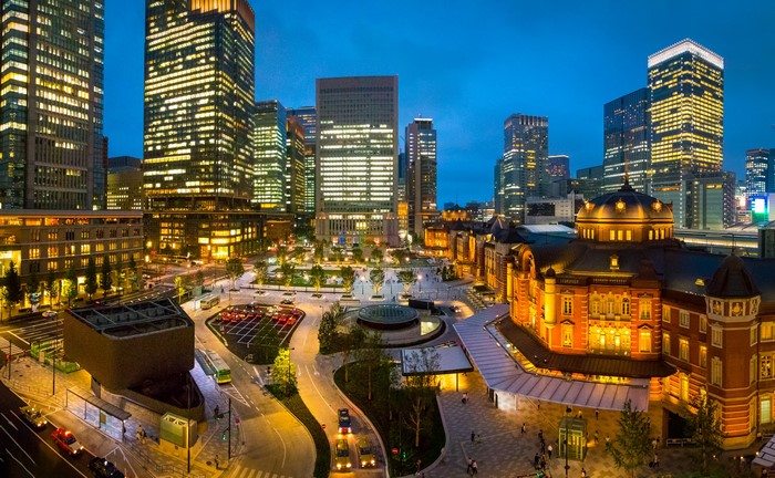 Tokyo Station at night with skyscrapers