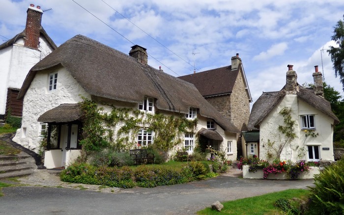 Thatched cottages in a village street in Devon, United Kingdom