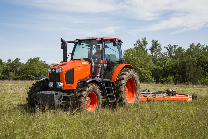 Kubota M6-141 tractor mowing a field
