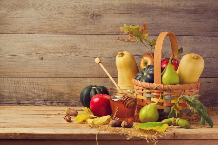 Autumn harvest with pumpkins, apples, pears, and honey