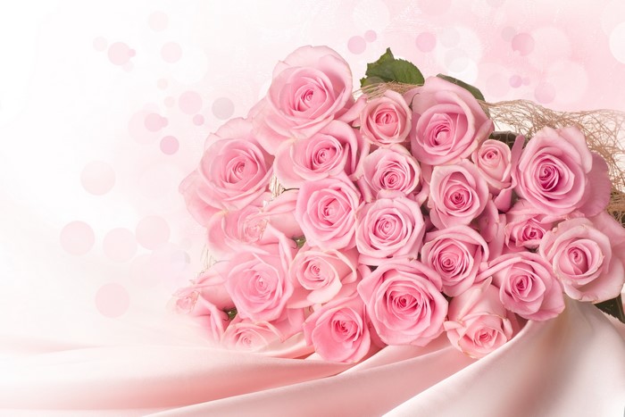 Bouquet of pink roses on pink silk