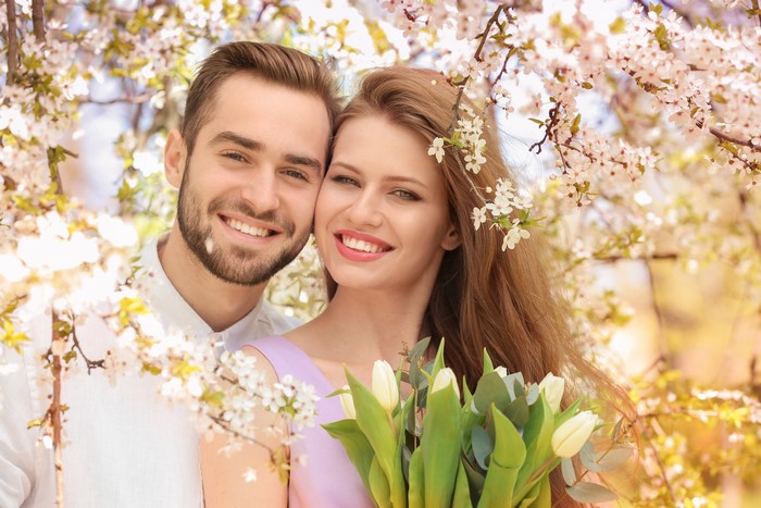 Couple Smiling with Tulips and Blossoms
