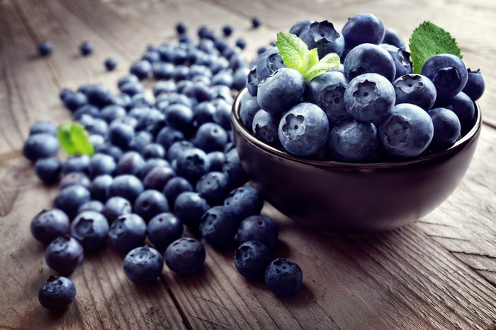Blueberries in a bowl on wooden table
