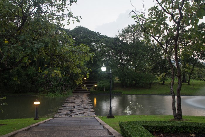 Park with pond, stairs, and street lights in Bangkok