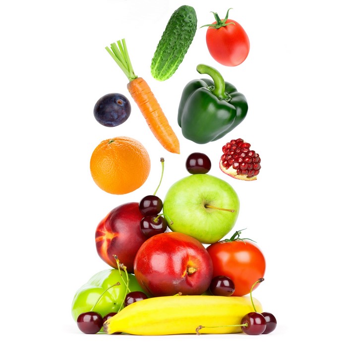 Assortment of fresh fruits and vegetables falling