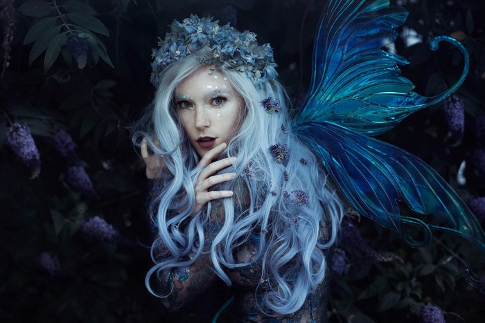 Fairy with blue wings and flower crown