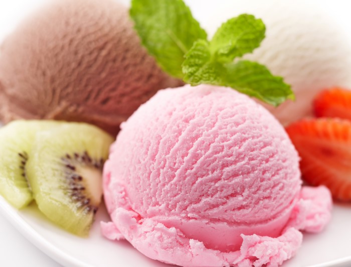 Scoops of ice cream with fruit and mint