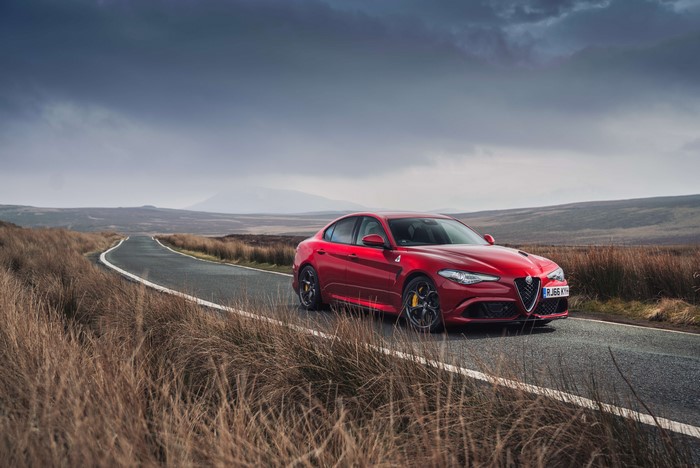 Red Alfa Romeo Giulia Quadrifoglio on a Road