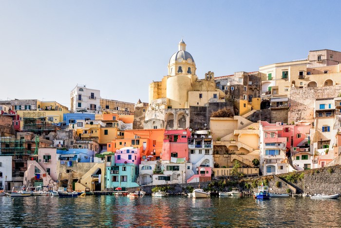 Colorful houses on a hillside by the water in Procida, Italy