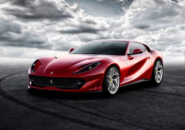 Red Ferrari 812 Superfast on a dark road