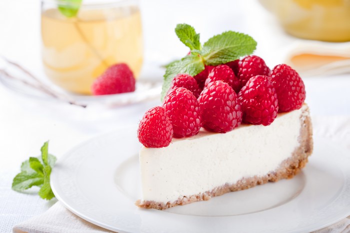 Slice of Raspberry Cheesecake with Mint and Tea