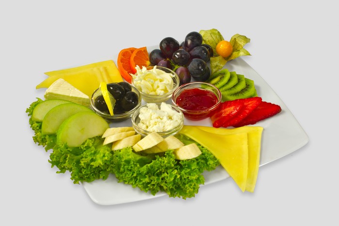 Cheese and fruit platter with olives and jam