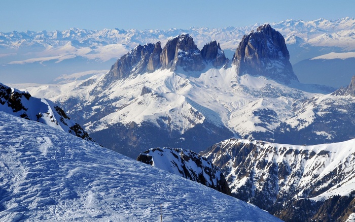 Snowy mountain range with jagged peaks under a clear blue sky