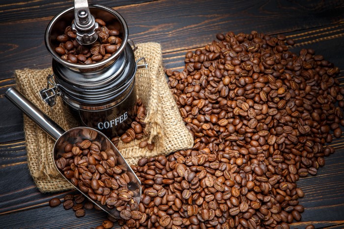Coffee beans and grinder on a wooden table