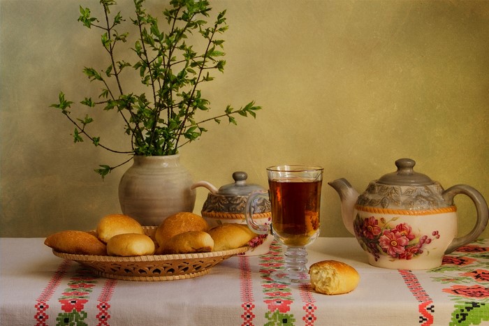 Still-life with tea, pastries, and flowers