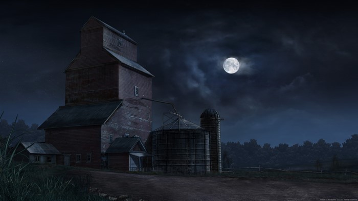 Grain elevator and silos at night under the moon