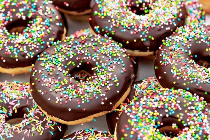 Chocolate donuts with colorful sprinkles