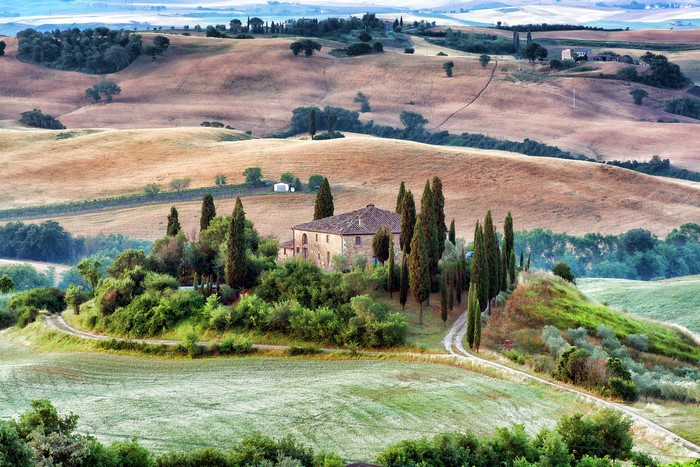 Tuscan Villa surrounded by rolling hills and cypress trees