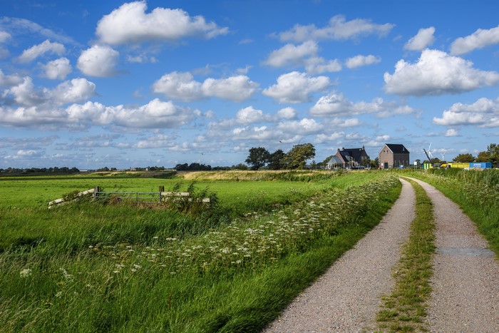 Roads and fields in Kolhorn, Netherlands under a cloudy sky