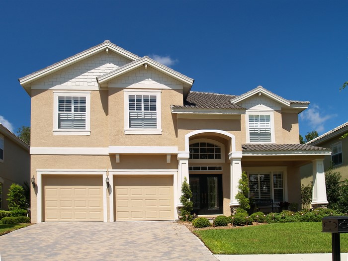 Two-story house with a double garage and manicured lawn