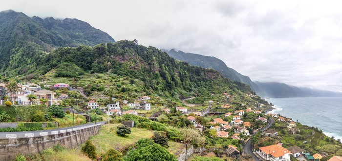 Houses on a steep mountainside overlooking the ocean in Madeira