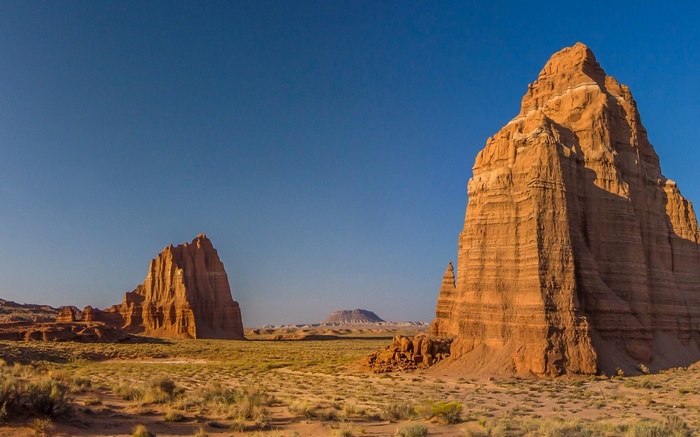 Desert landscape with rock formations and clear blue sky