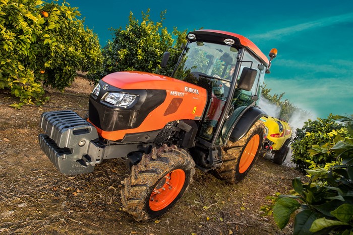 Kubota M5101N tractor spraying orange grove