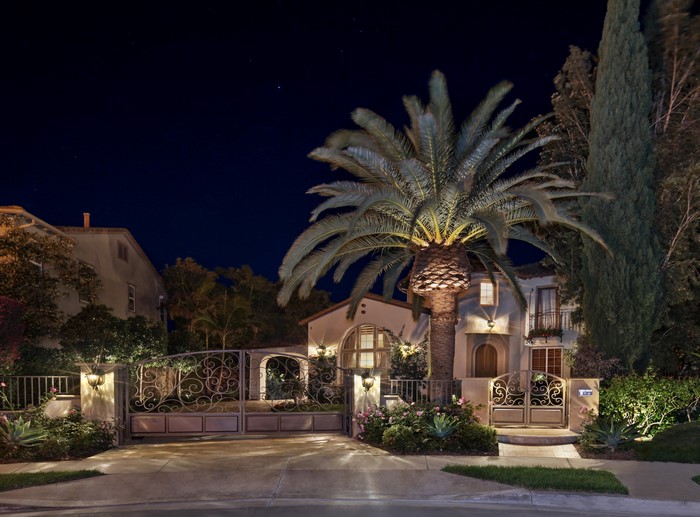 Luxury Mansion with Ornate Gates and Palm Trees at Night in San Clemente, USA