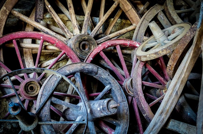 Pile of old wooden wagon wheels