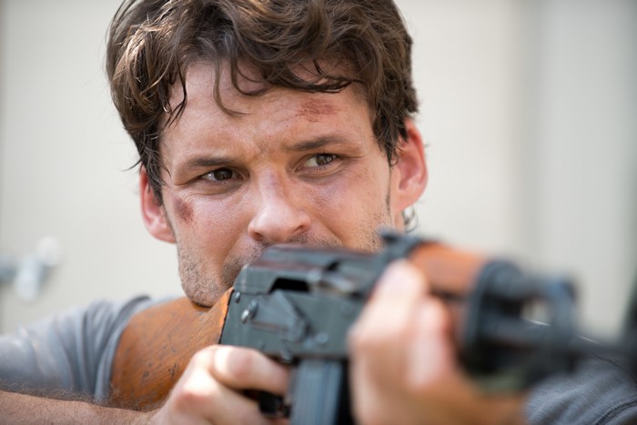Austin Nichols as Spencer holding a rifle