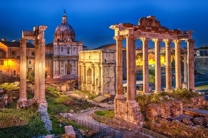 Roman Forum ruins with ancient columns and church at dusk