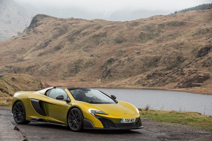 Yellow 2016 McLaren 675LT Spider by a Lake