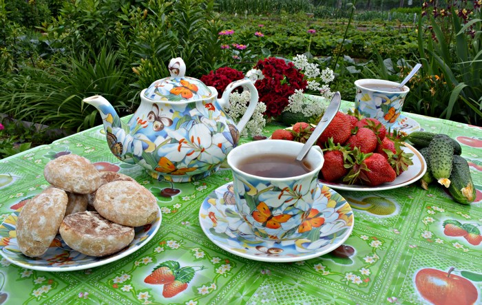 Still-life of tea set with strawberries and cucumbers