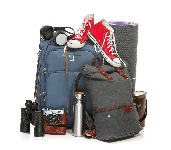 Travel gear: suitcase, backpack, shoes, camera, headphones, binoculars, yoga mat