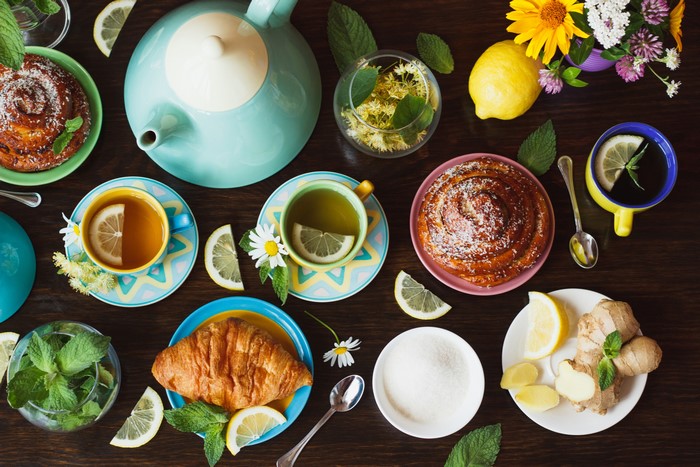 Tea set with pastries, lemons, and ginger