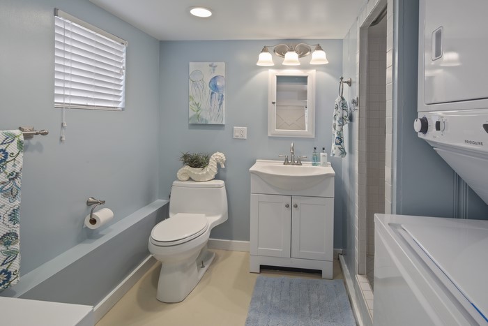 Bathroom with toilet, sink, and washing machine