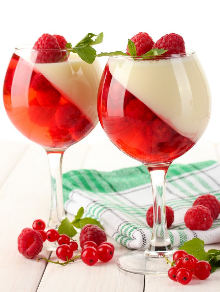 Two glasses of raspberry and cream jelly with fresh berries